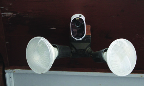 A motion-activated light hung up with two lights facing out.